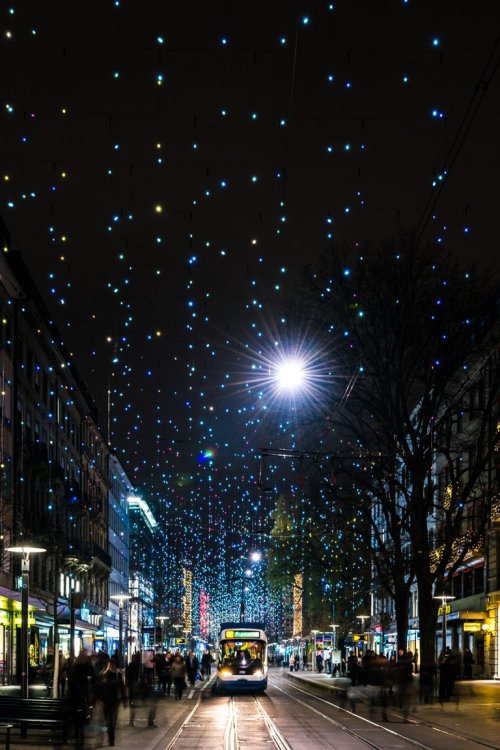 Bild der Zürcher Bahnhofstrasse bei Nacht mit der Weihnachtsbeleuchtung Lucy, einer über der Strasse hängenden Lichtinstallation